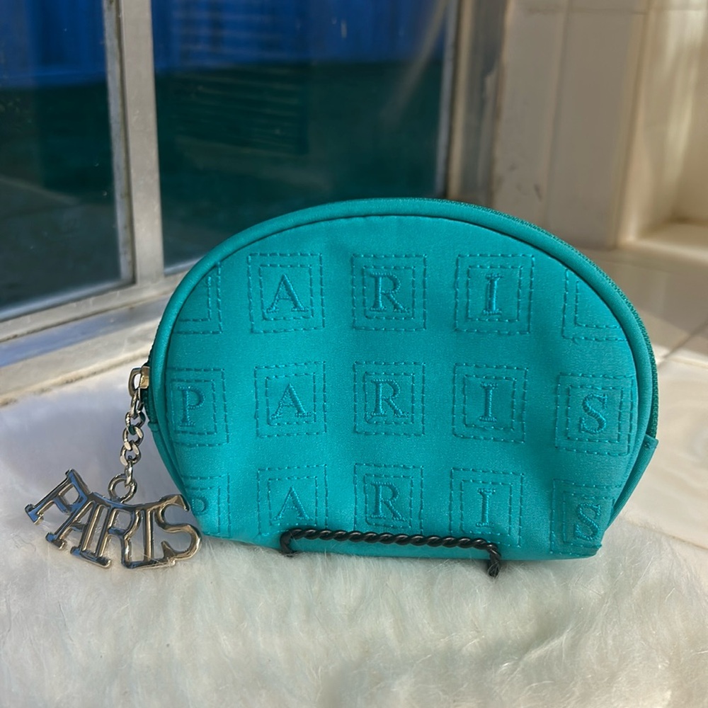 Mini cosmetic pouch with PARIS zipper pull tag.